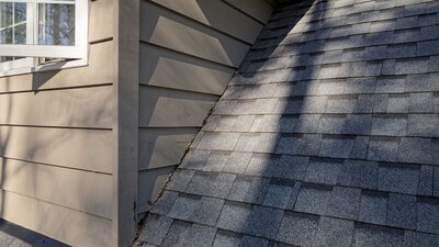 A roof with missing dormer flashing